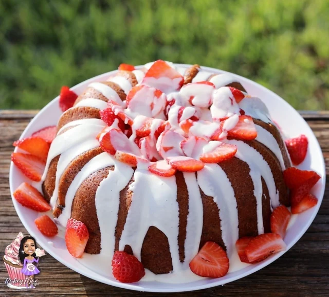 Strawberry-topped Bundt by Kakey Mae. A Bundt cake dressed with white glaze, red drizzle, and sliced strawberries.