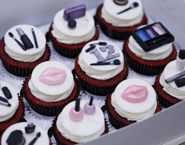 Makeup birthday cupcakes by Kakey Mae. Handmade makeup-inspired details, pink lips, and a personalized birthday number.