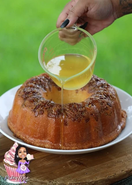 A Bundt finishing touch by Kakey Mae. A freshly baked Bundt cake being finished with a pour of golden glaze.
