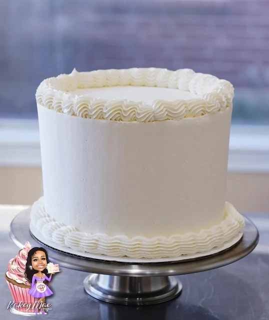 Classic white celebration cake by Kakey Mae. Smooth white frosting with carefully piped borders around the top and base.