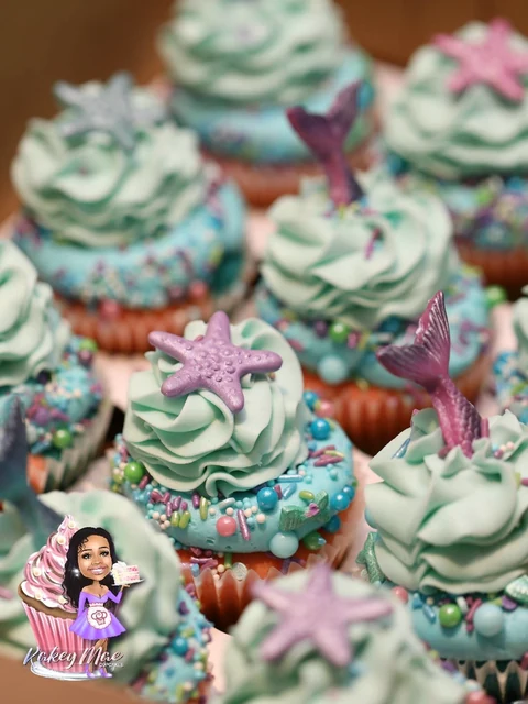 Mermaid party cupcakes by Kakey Mae. Coordinated turquoise swirls, mermaid tails, starfish, and pastel sprinkles.