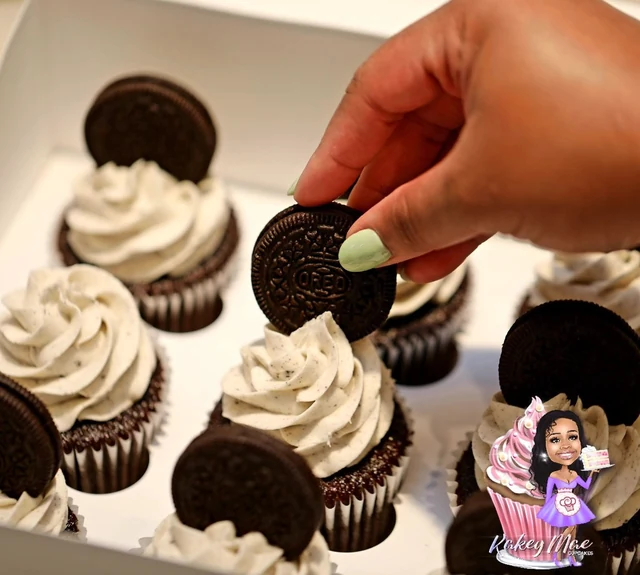 The cookie finishing touch by Kakey Mae. A cookie being placed into a white frosting swirl to finish a cupcake.