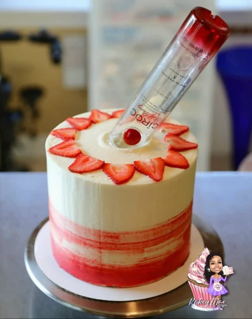 Strawberry & spirits cake by Kakey Mae. A red-and-white cake topped with strawberry slices and a spirit bottle.