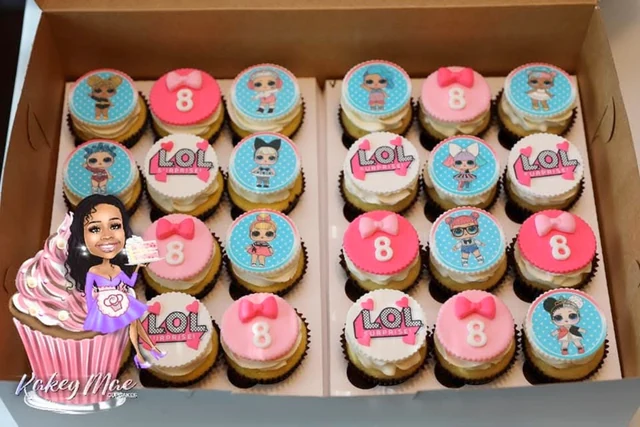 Character party cupcakes by Kakey Mae. A coordinated box of pink and blue cupcakes with character toppers and birthday numbers.