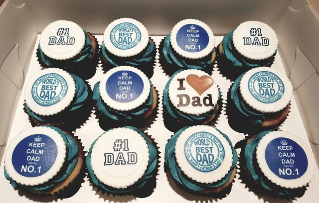 Father’s Day cupcakes by Kakey Mae. A boxed collection of blue-and-white cupcakes with a different message for Dad on each topper.