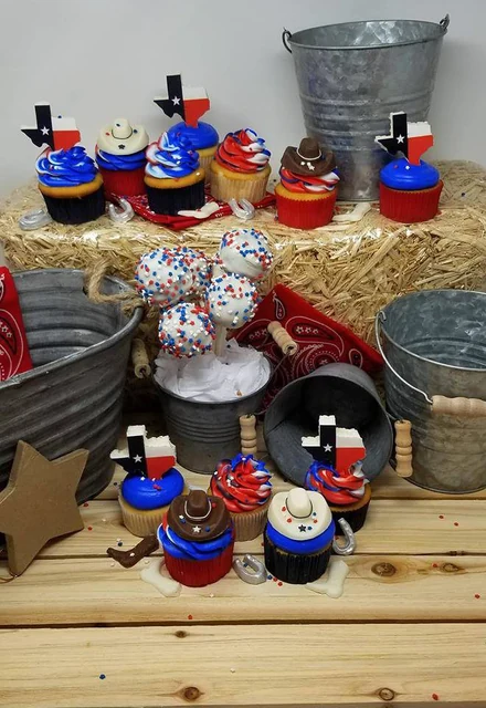 Red, white & blue party set by Kakey Mae. Color-coordinated cupcakes arranged with miniature hats and themed decorations.