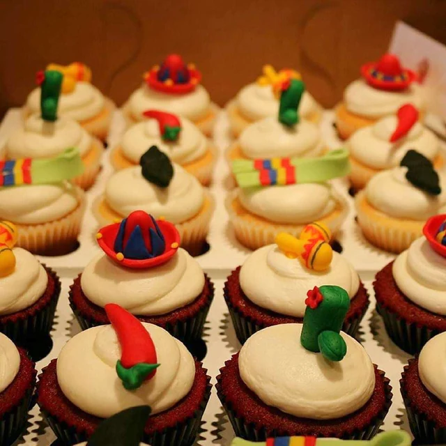 Fiesta-inspired details by Kakey Mae. Miniature hats, cactus shapes, and bright striped fondant accents.