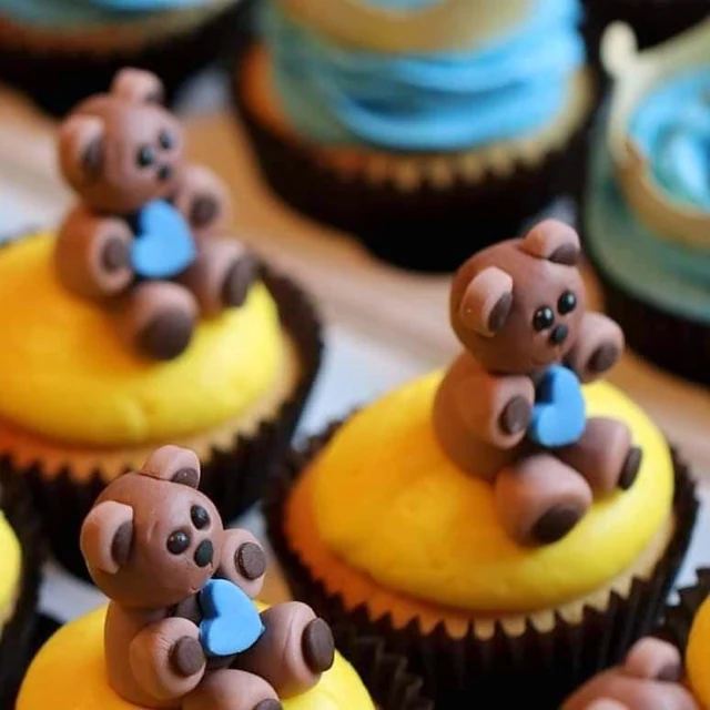 Teddy bear details by Kakey Mae. A close-up of sculpted teddy bears and their tiny blue bows.